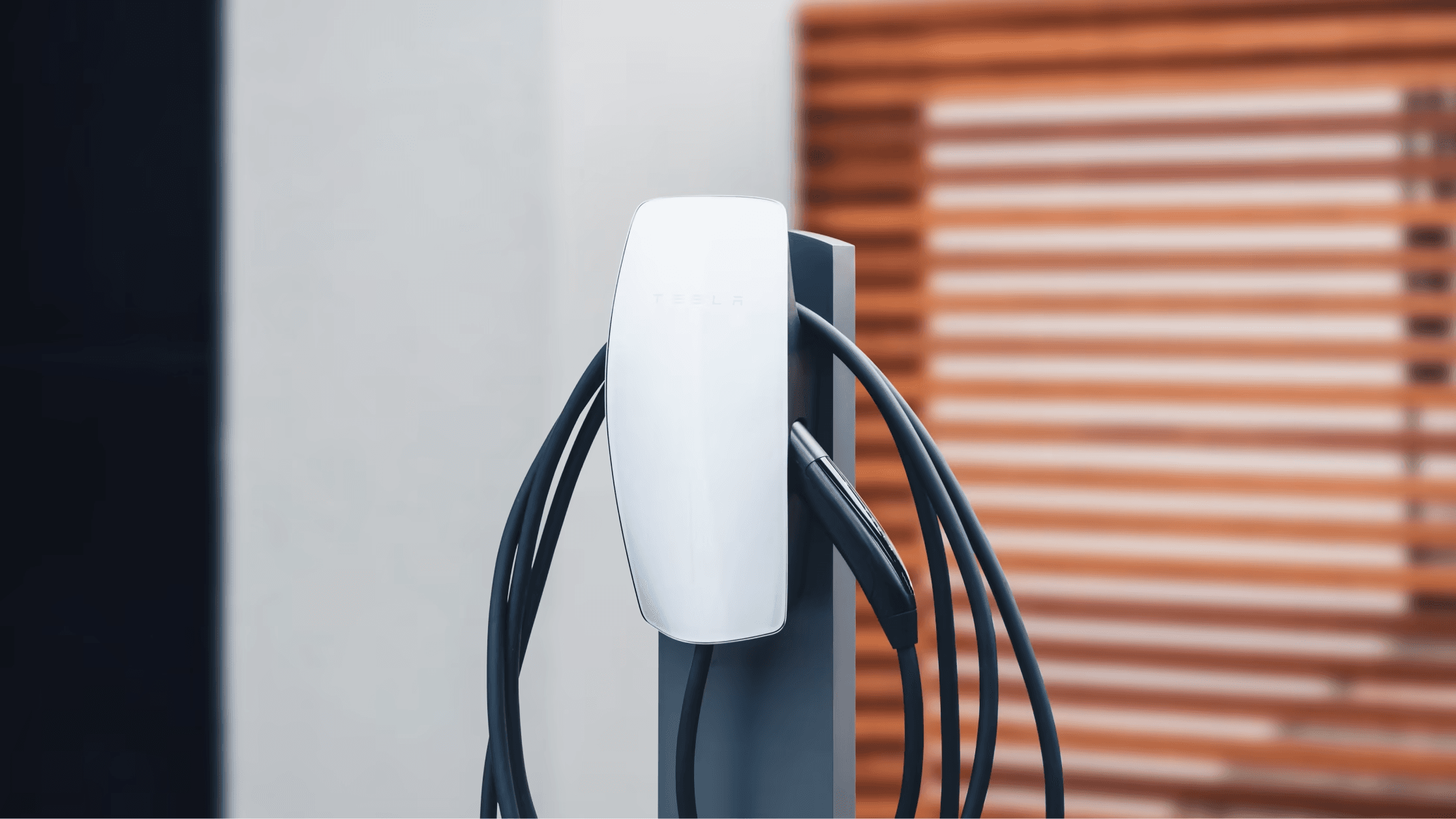 Close-up of a Tesla Wall Connector and tethered charging cable